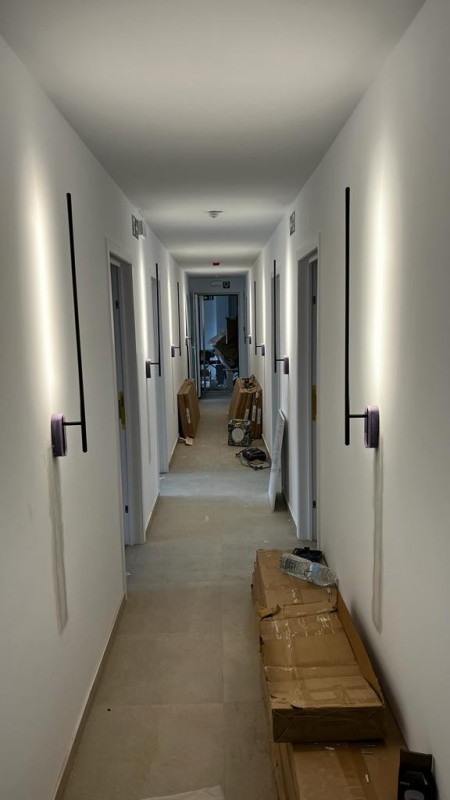A dimly lit hallway with a closed door at the end, inviting you to explore the mysteries beyond.