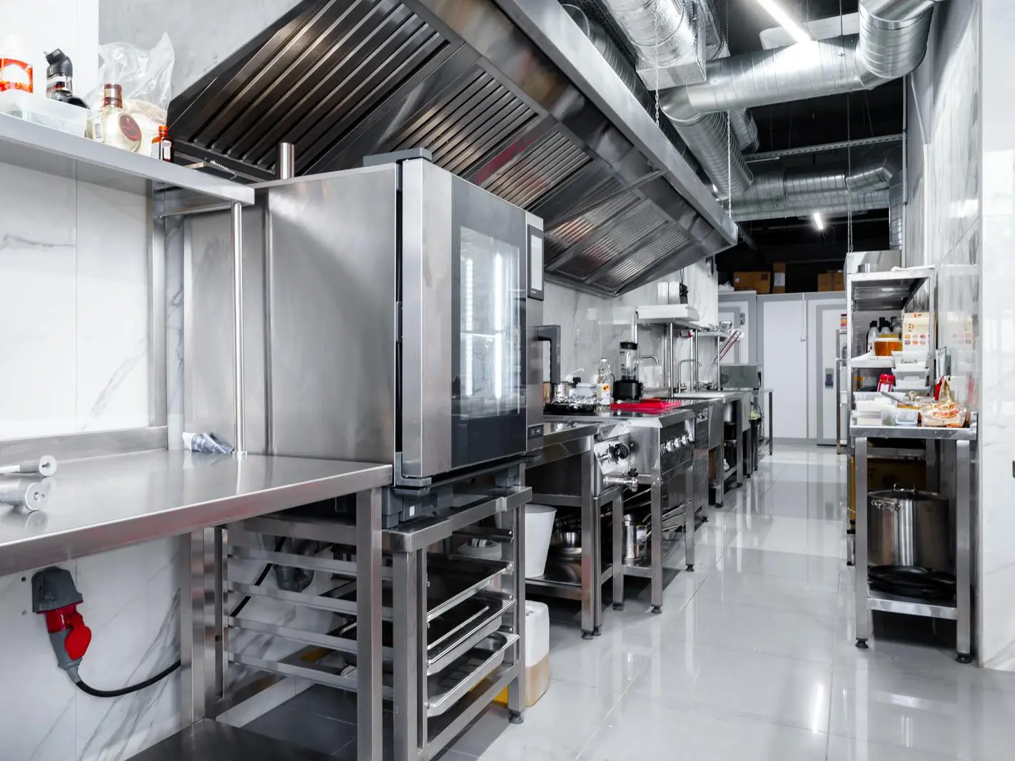 Professional-grade stainless steel appliances in a commercial kitchen setting. Modern commercial kitchen with sleek stainless steel appliances for efficient cooking.