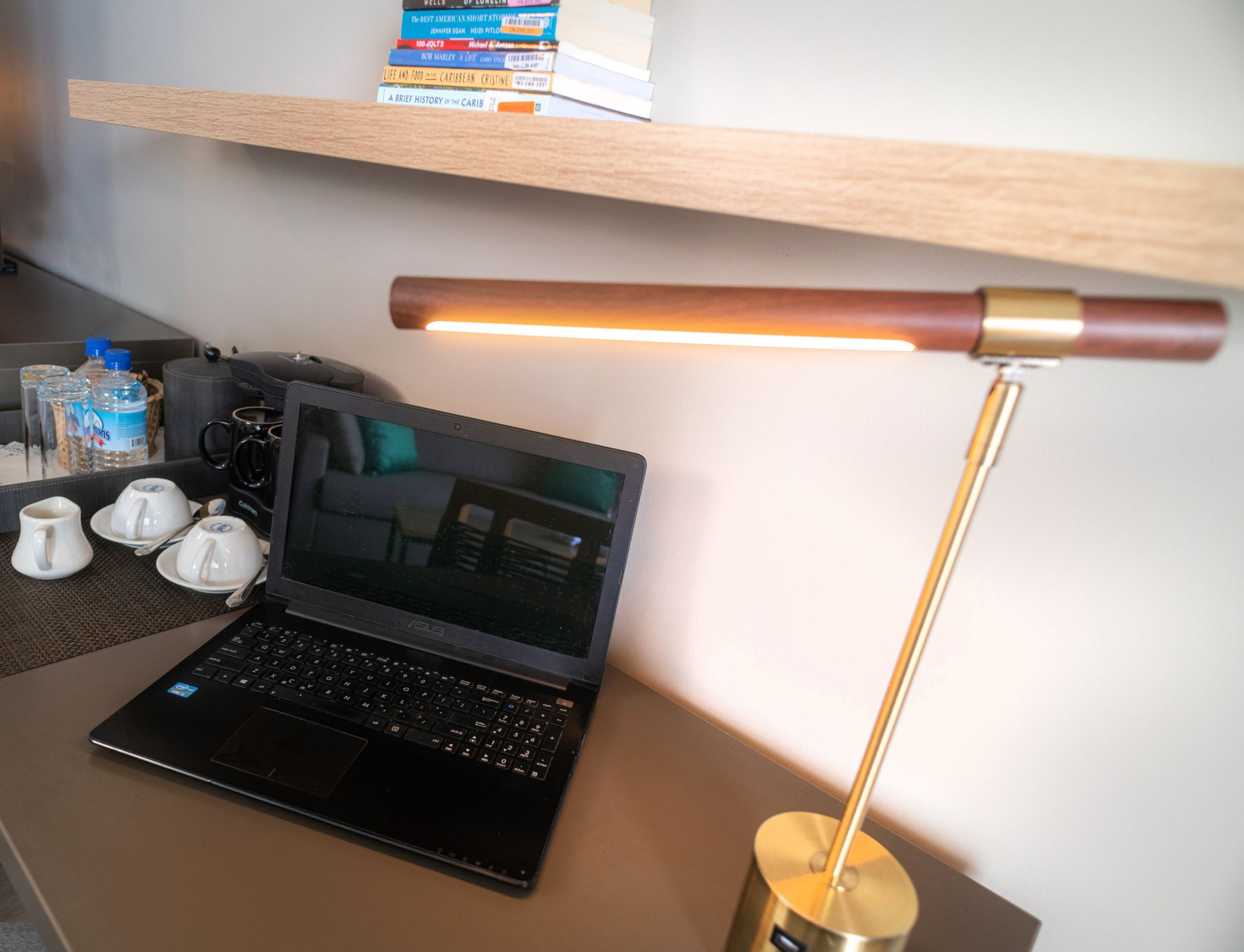 A laptop computer and a lamp on a desk, ready for work or study.