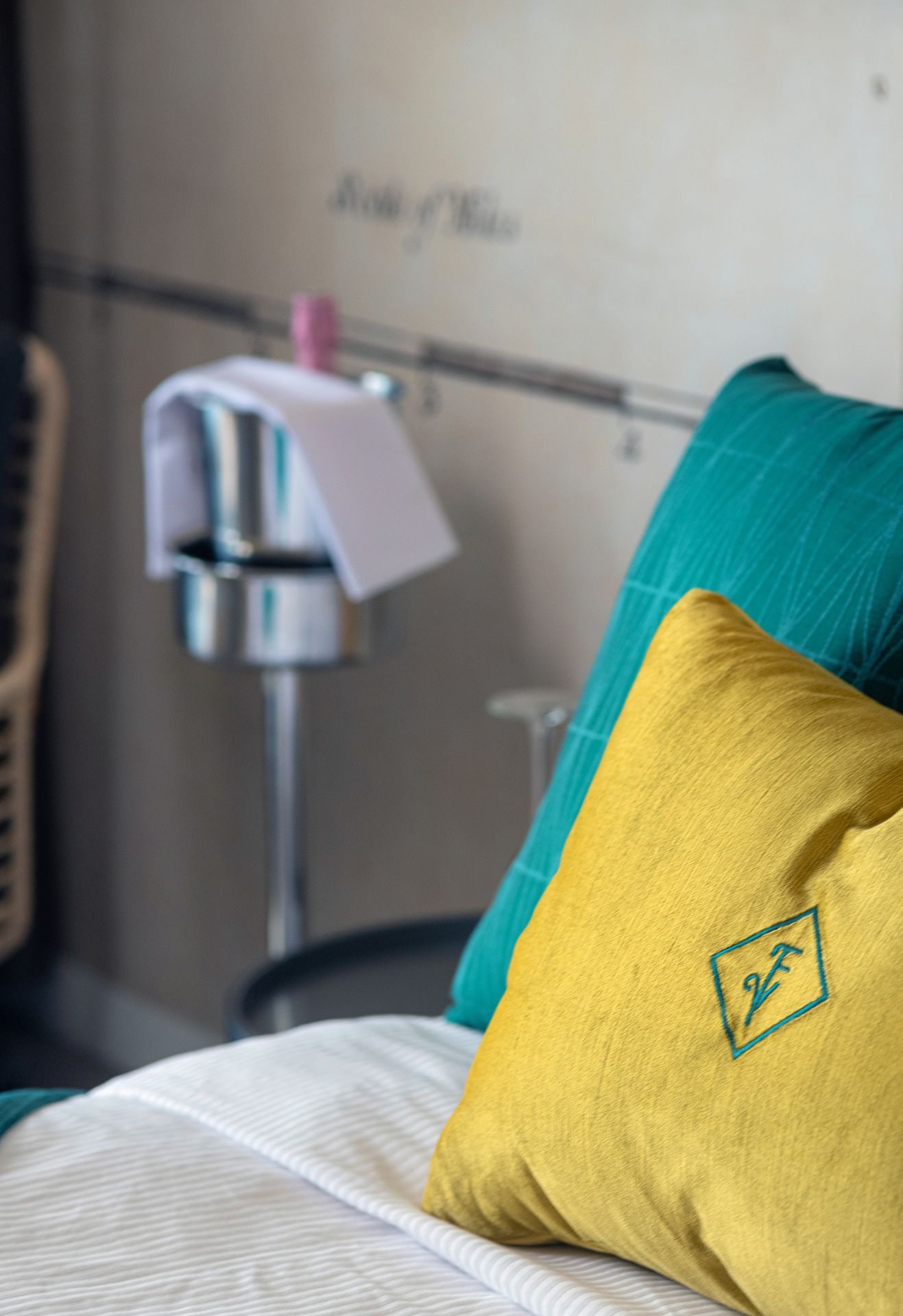 A cozy bed with a vibrant yellow pillow and a refreshing green pillow, creating a perfect blend of comfort and style.