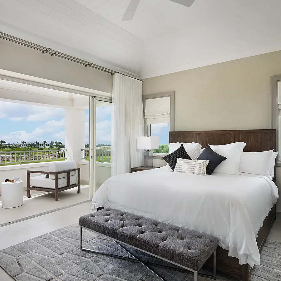 bedroom overlooking the ocean, with a large comfortable bed. Oceanfront bedroom with spacious bed and stunning view.