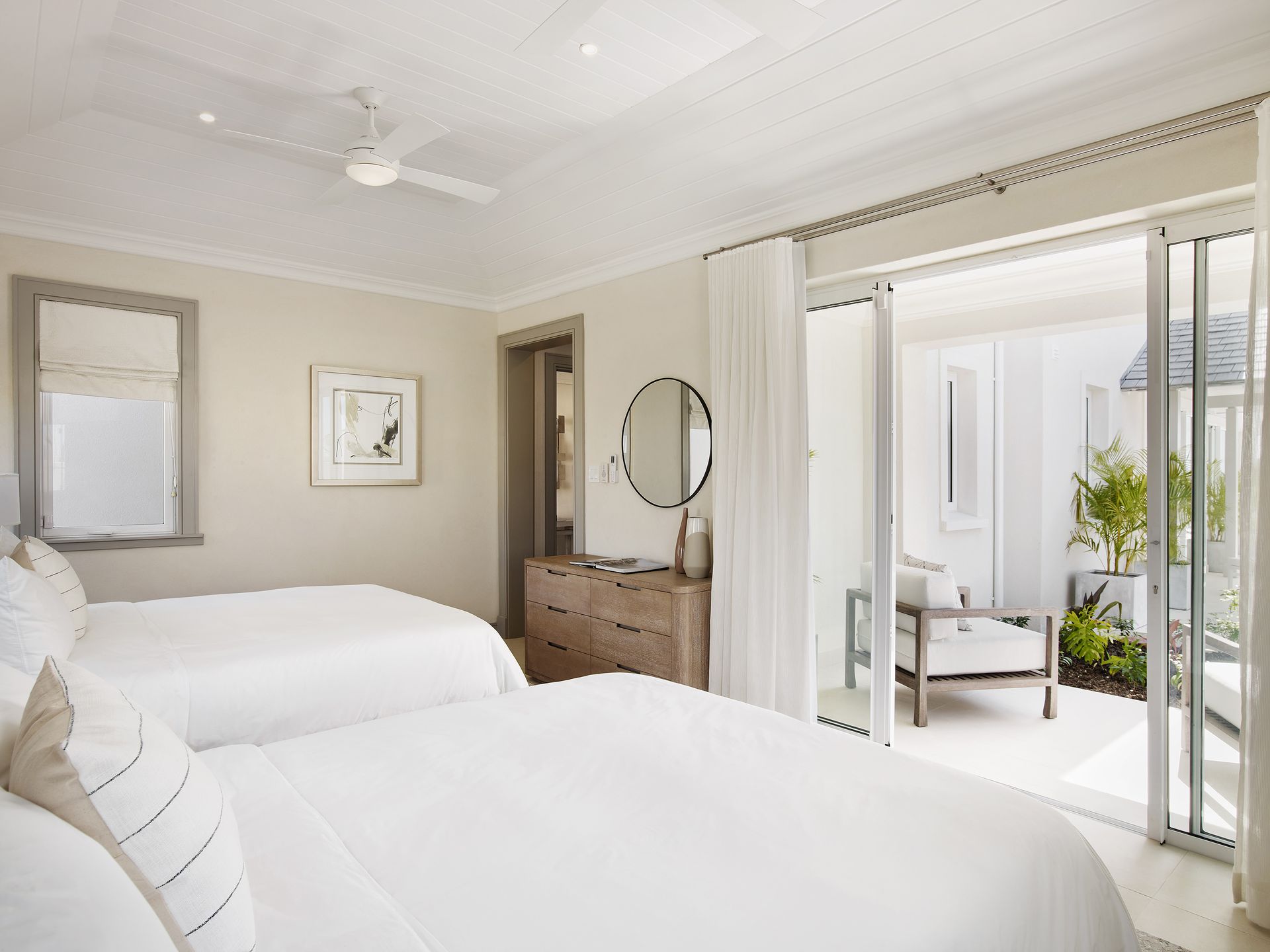 Bedroom featuring two beds and a sliding glass door