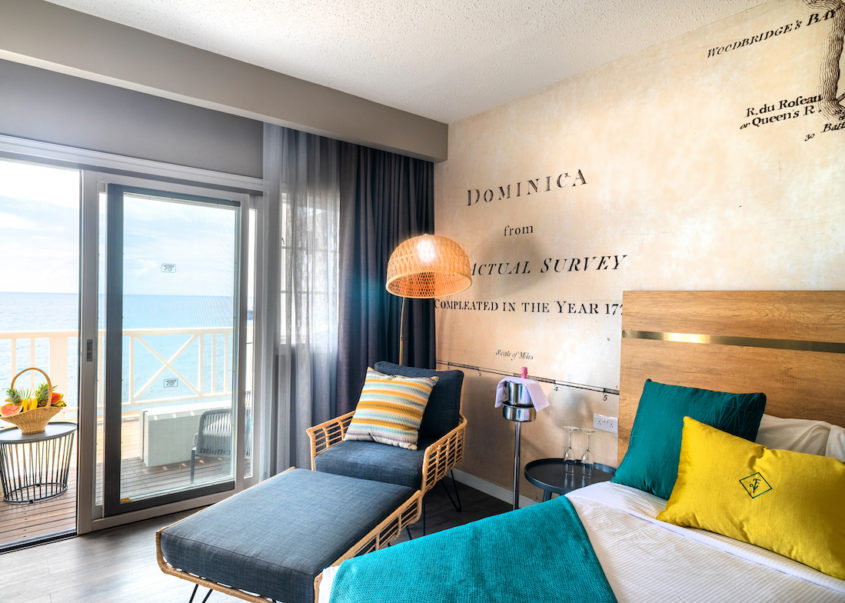 Luxurious hotel room with elegant bed, plush chair, and a wall adorned with a stylish map.