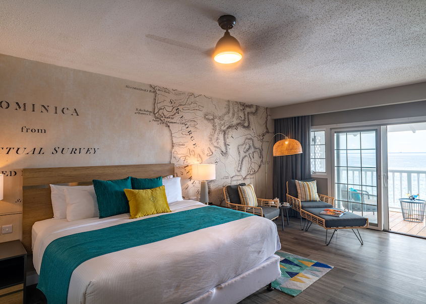 A cozy hotel room with a comfy bed, a TV, and a wall map to plan your adventures.