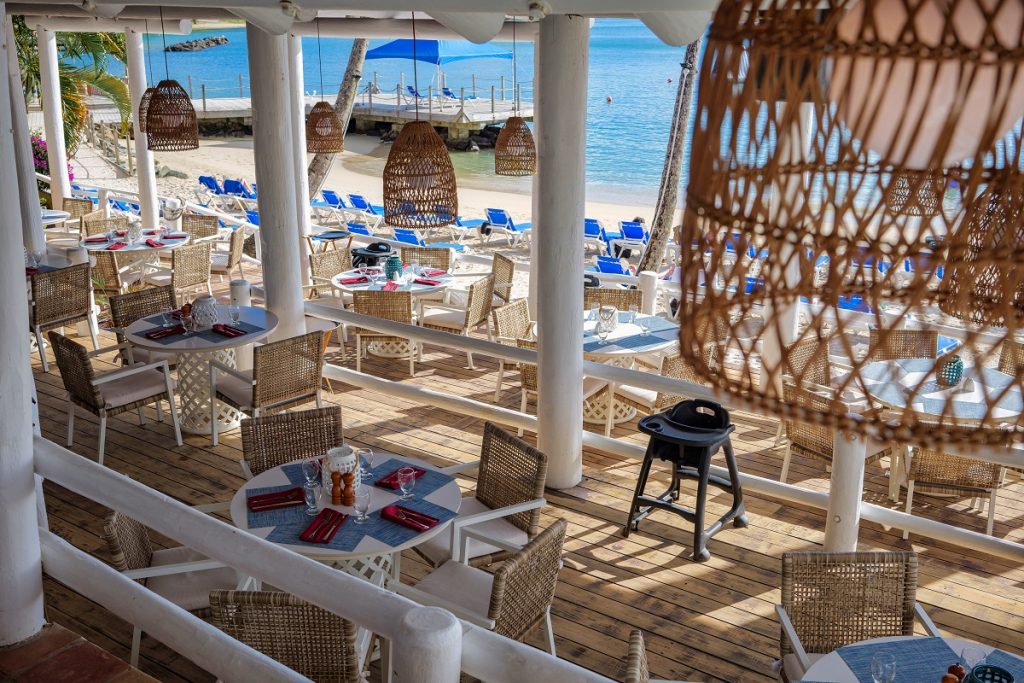 Beachfront restaurant with outdoor seating overlooking the ocean