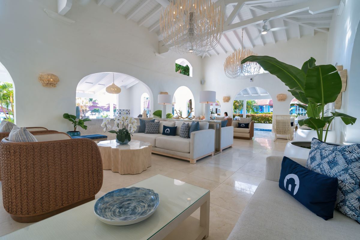 Luxurious living room with elegant white furniture and stylish blue accents.