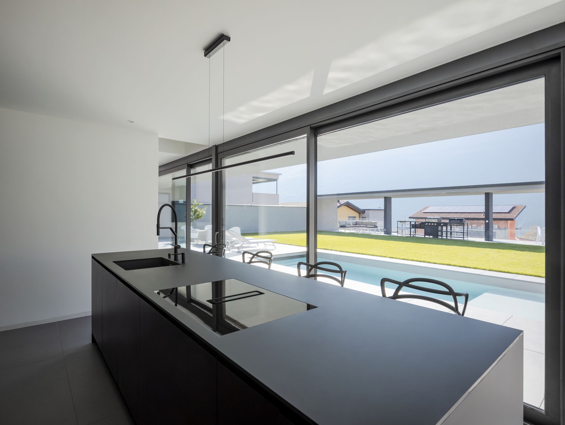 Spacious kitchen with window facing pool.