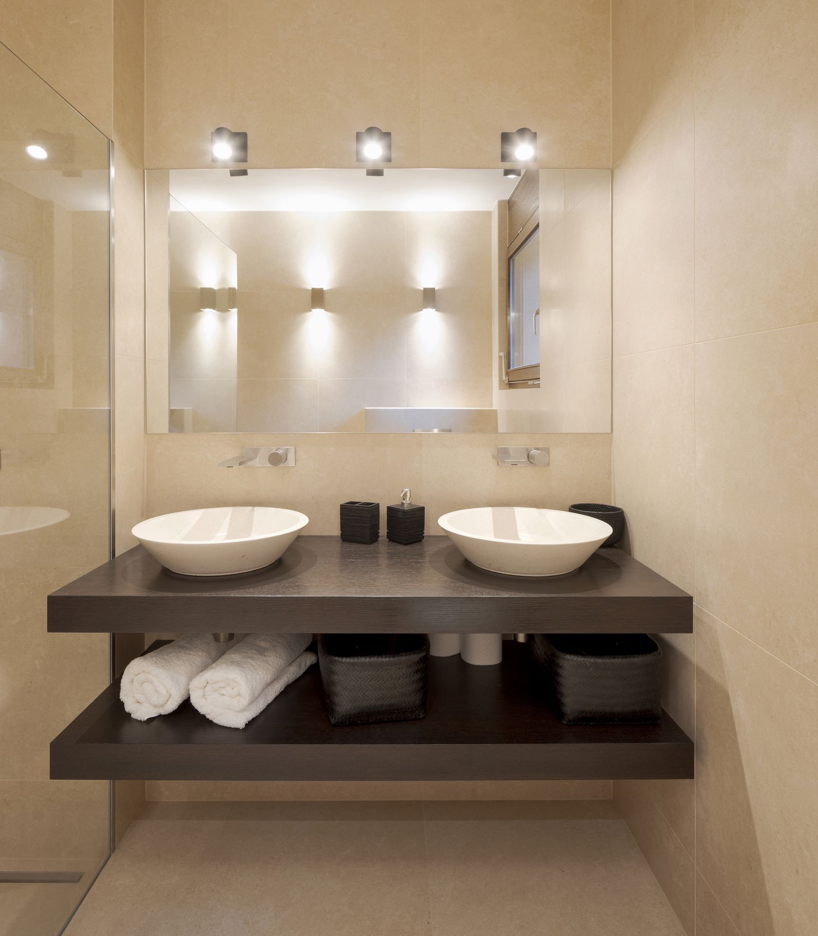 A modern bathroom with two sinks and a mirror.