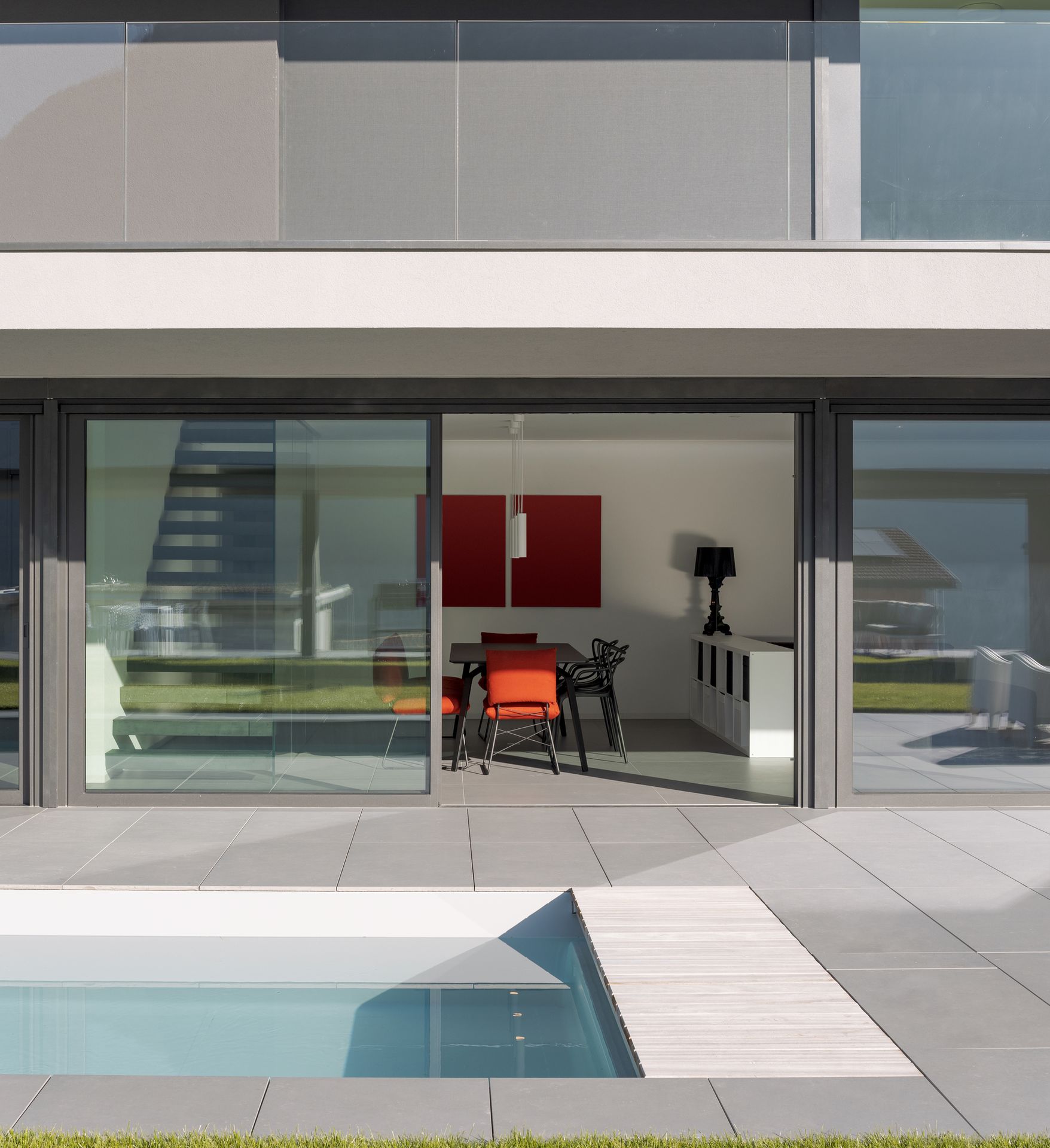 A contemporary house with a pool and patio, offering a perfect blend of style and relaxation.