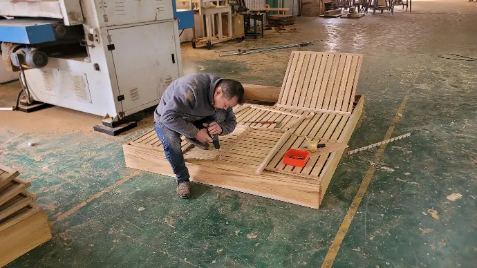 A skilled worker crafting and assembling wooden furniture A skilled worker crafting and assembling wooden furniture