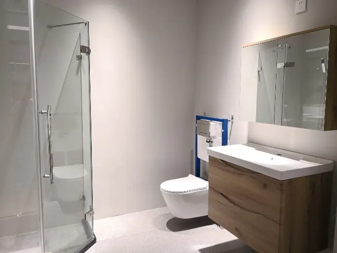 A well-designed bathroom showcasing a porcelain toilet A clean bathroom arranged for optimal functionality